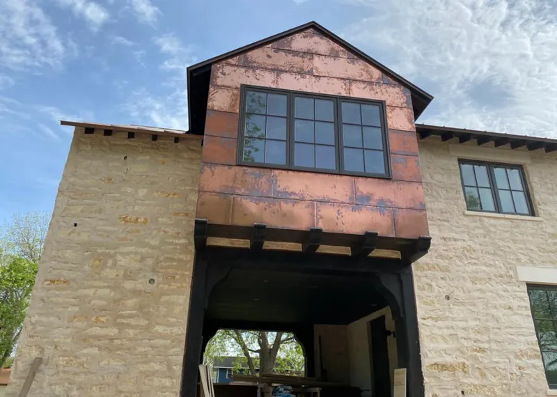 Copper metal panel facade on a stone building for Skylight Installation in Sunset Hills